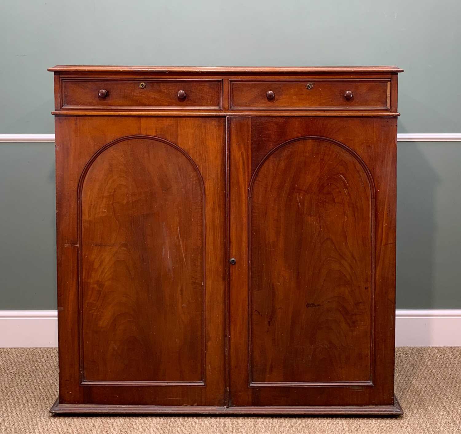 19TH CENTURY MAHOGANY CABINET, fitted two drawers above arch panelled doors enclosing sliding