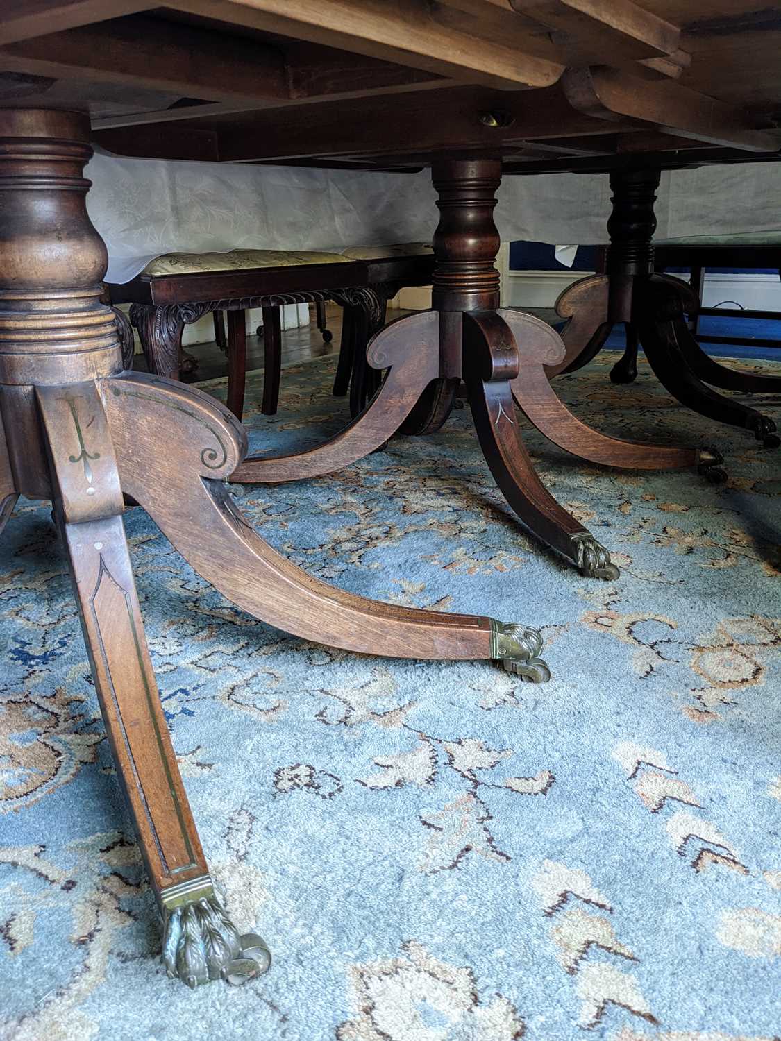 REGENCY TRIPLE-PEDESTAL MAHOGANY DINING TABLE, double reeded top above ringed columns, with brass - Image 11 of 11