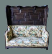 19TH CENTURY STAINED OAK WINGBACK SETTLE, later upholsterd in printed fabric, high panelled 2-