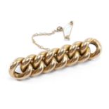 15CT GOLD CUNKY CURB LINK BAR BROOCH, with safety chain, 5.2cms long, 8.8gms Provenance: deceased