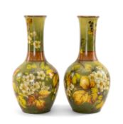 LARGE PAIR OF DOULTON FAIENCE VASES, overall decorated with flowers and foliage on a green ground,
