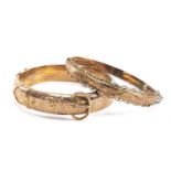 TWO 9CT GOLD HINGED BANGLES, one with buckle design and engraved, 24.5gms gross (2) Provenance: