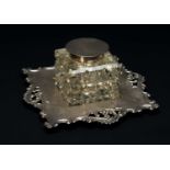 EDWARD VI SILVER MOUNTED CUT GLASS INKSTAND, foliate and pierced C-scroll border stand, circular