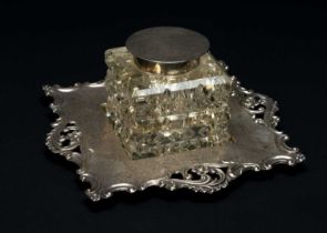 EDWARD VI SILVER MOUNTED CUT GLASS INKSTAND, foliate and pierced C-scroll border stand, circular