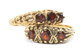 TWO 9CT GOLD THREE STONE GARNET RINGS, one with diamond chips, 5.3gms gross (2) Provenance: