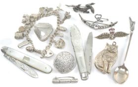 ASSORTED SILVER COLLECTIBLES, including charm bracelet with 13 charms, Christmas cracker brooch,