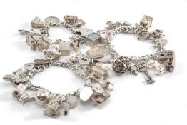 THREE SILVER CHARM BRACELETS, filled with 16, 15 & 10 charms each, tot appr wt. 6.1ozt (3)