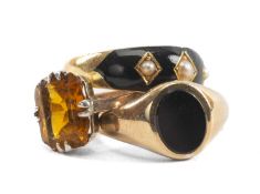 THREE GOLD RINGS comprising 15ct gold and enamel seed pearl ring, 9ct gold onyx ring and a 9ct