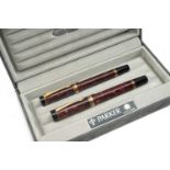 PARKER PEN SET, comprising pair marbled burgundy Parker Duofold Centennial rollerball and fountain