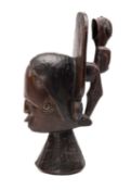 IDOMA HEAD CREST, Nigeria, with flat rear flange supporting rear standing figure, 36cms high