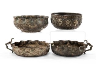INDIAN WHITE METAL BOWLS, comprising a pair with entwined cobra handles and wavy rims, another