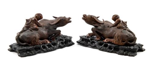 PAIR CHINESE CARVED WOOD SCULPTURES OF 'BOYS ON BUFFALOES', with inset opaque glass eyes and bone