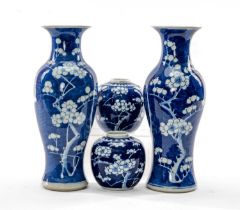 FOUR CHINESE BLUE & WHITE VASES, painted with flowering prunus, including near pair baluster