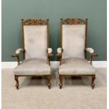 A PAIR OF VINTAGE ARTS & CRAFTS-STYLE OAK UPHOLSTERED ARMCHAIRS having carved leaf detail to the