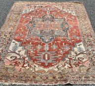 EASTERN RUG DECORATED WITH CENTRE DIAMOND of red ground, multi-bordered edge, 370cms L x 265cms W