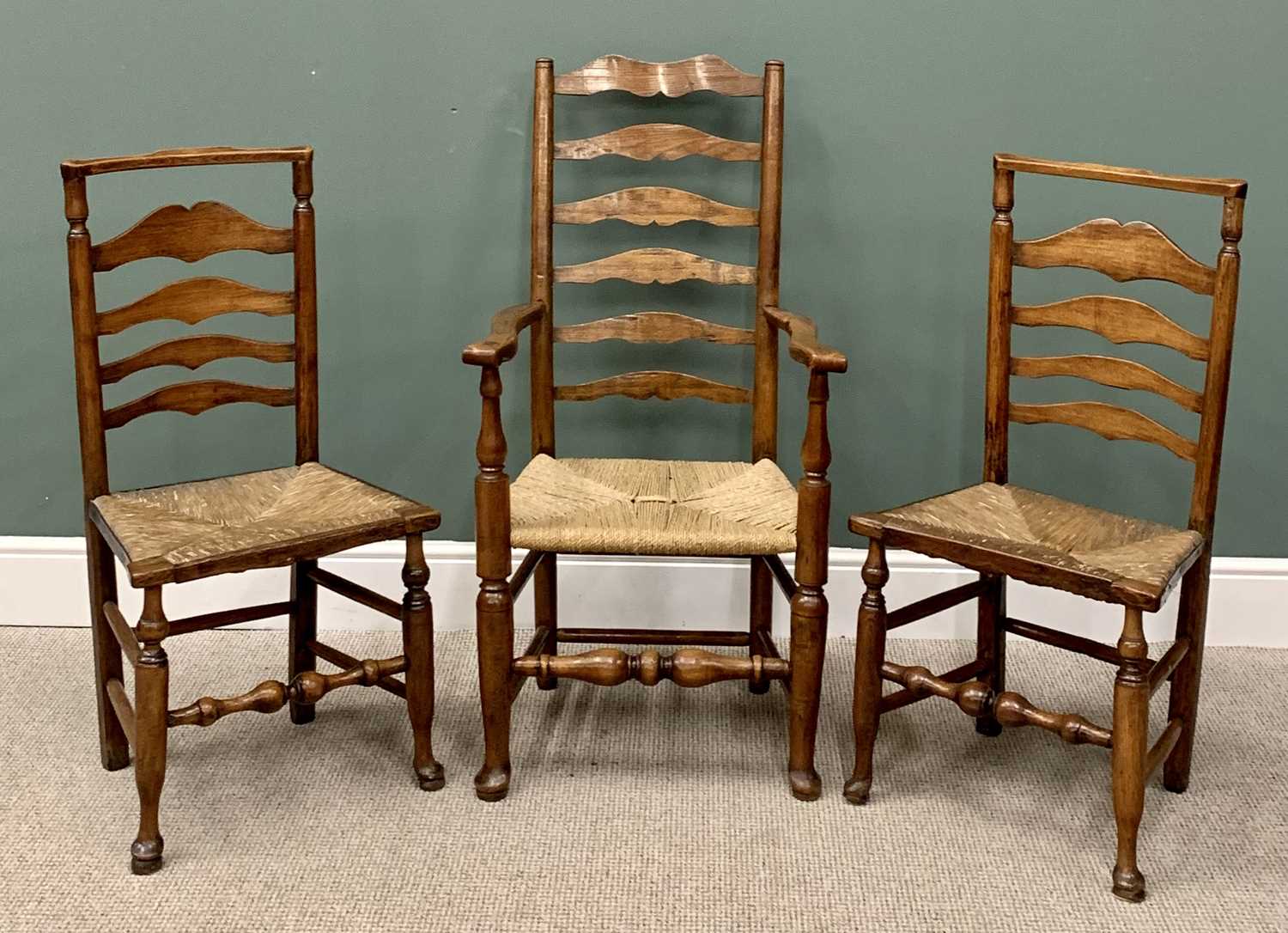 THREE RUSH SEATED LADDERBACK CHAIRS including one carver, on hoof supports, 114cms H, 60cms W, 43cms - Image 2 of 3