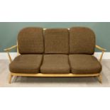 MID-CENTURY ERCOL LIGHTWOOD THREE-SEATER COUCH with spindle back and six cushions, 77cms H, 179cms
