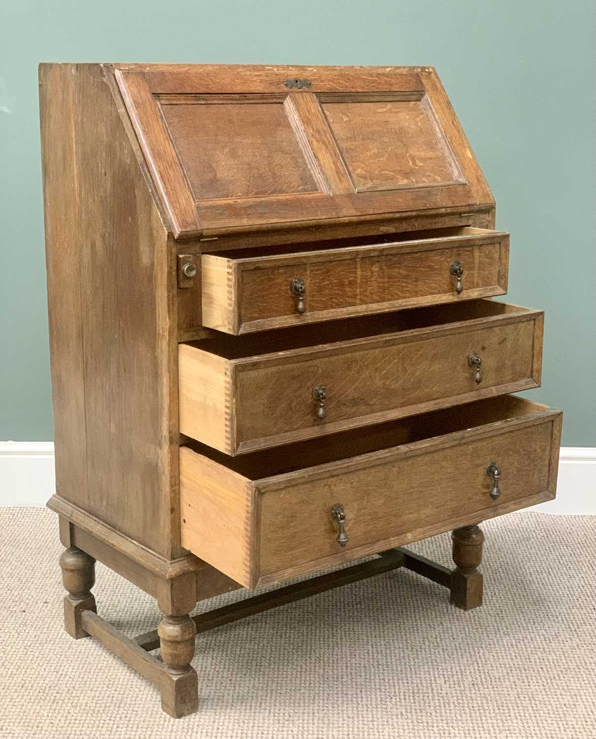 VINTAGE OAK BUREAU having a drop down slope section over three drawers with cast drop handles on - Image 3 of 4