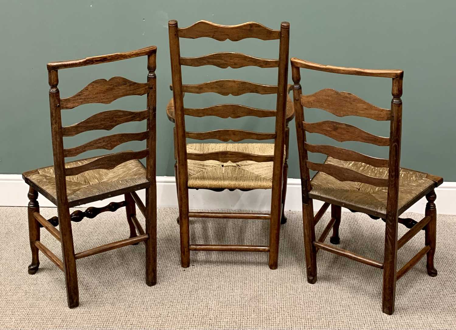 THREE RUSH SEATED LADDERBACK CHAIRS including one carver, on hoof supports, 114cms H, 60cms W, 43cms - Image 3 of 3