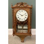 AMERICAN WALL CLOCK having a walnut case with bobbin pillars and carved crest, bell strike movement,