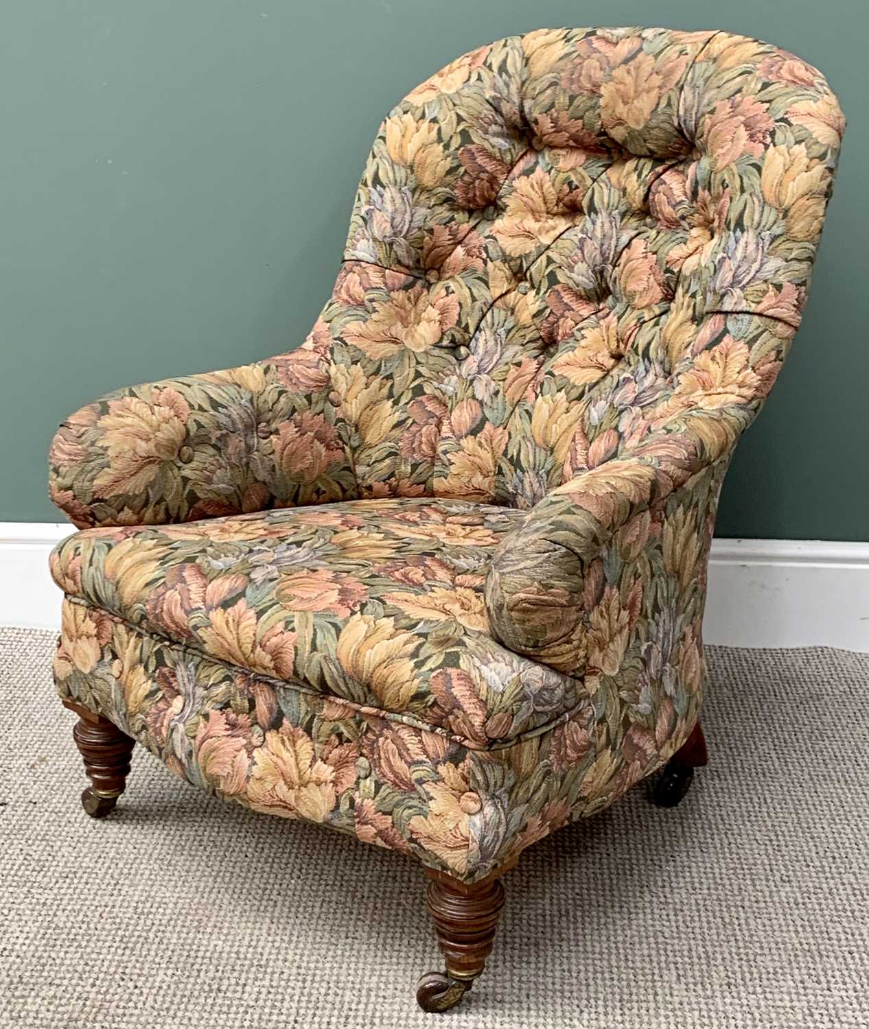 EDWARDIAN BUTTON BACK UPHOLSTERED TUB ARMCHAIR in floral upholstery, on turned front supports and