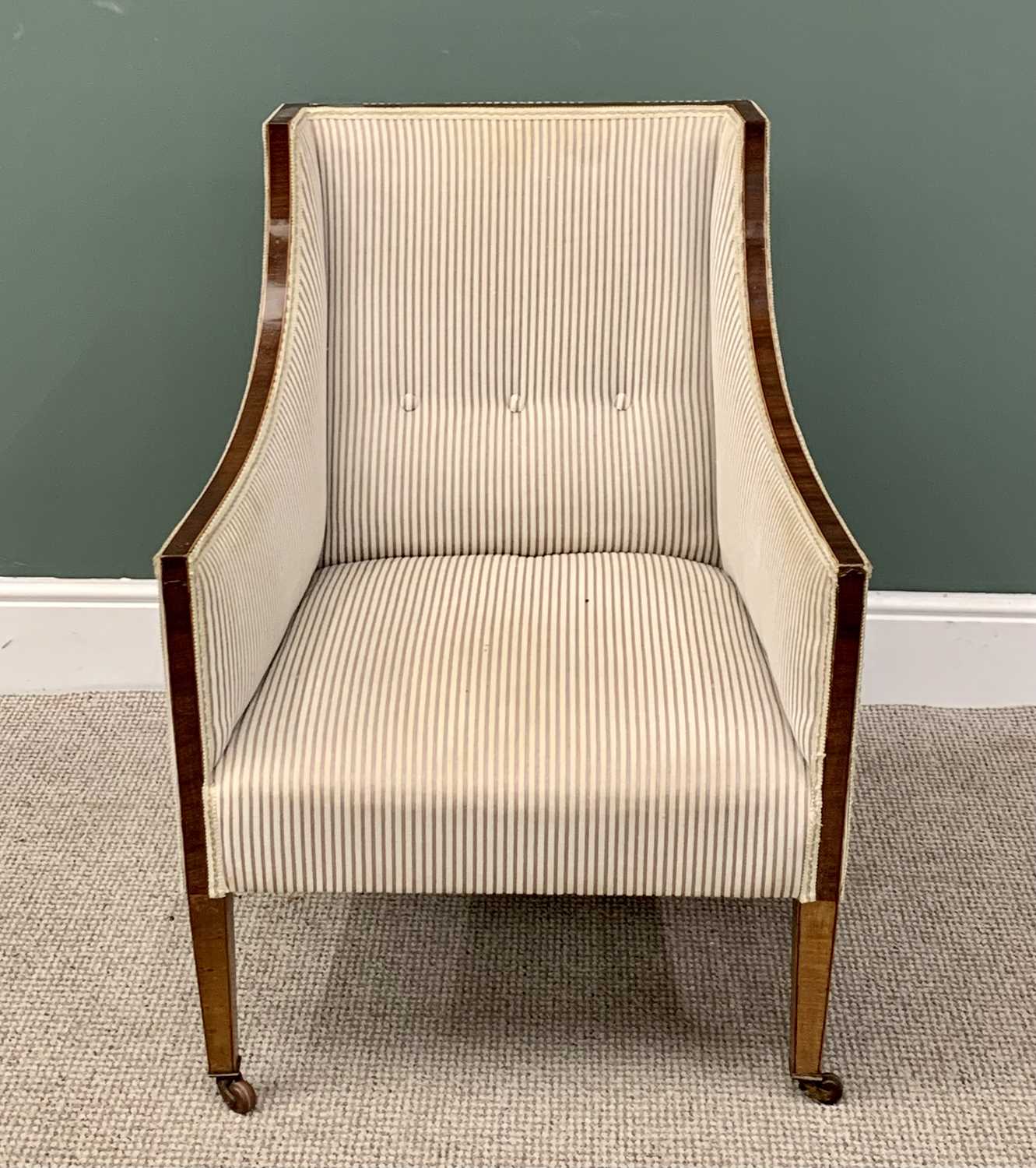 REGENCY-STYLE EDWARDIAN UPHOLSTERED EASY CHAIR in button back striped upholstery, on tapered front