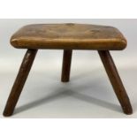 PRIMITIVE FRUITWOOD MILKING STOOL having a shaped seat on three stick legs, 20cms H, 28cms W,