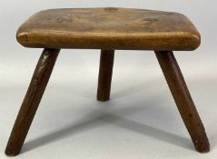 PRIMITIVE FRUITWOOD MILKING STOOL having a shaped seat on three stick legs, 20cms H, 28cms W,