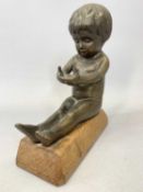 'HAILWARE' BRONZE FIGURE OF A SEATED CHILD with cupped hands, stamped 'Hailware', on rectangular oak