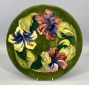 MOORCROFT 'HIBISCUS' PATTERN CIRCULAR SHALLOW DISH, green ground, with impressed marks, signed and