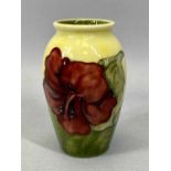 MOORCROFT 'HIBISCUS' PATTERN BALUSTER VASE, yellow / green ground with Queen Mary label, 11cms