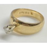 YELLOW GOLD WIDE BAND SOLITAIRE DIAMOND RING having a stand-up four claw mount, holding a 0.15ct