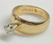 YELLOW GOLD WIDE BAND SOLITAIRE DIAMOND RING having a stand-up four claw mount, holding a 0.15ct