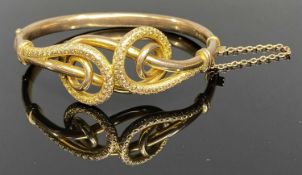 CHESTER 1907 9CT GOLD HOLLOW CORE BANGLE by Joseph Hawkins, the top having an openwork design of two