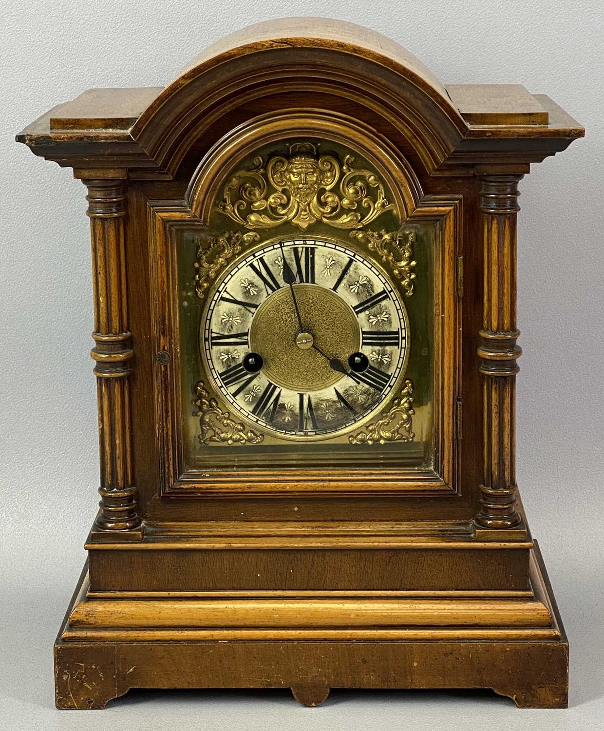 WALNUT CASED MANTEL CLOCK, early 20th Century, the case with dome top, arched door flanked by reeded