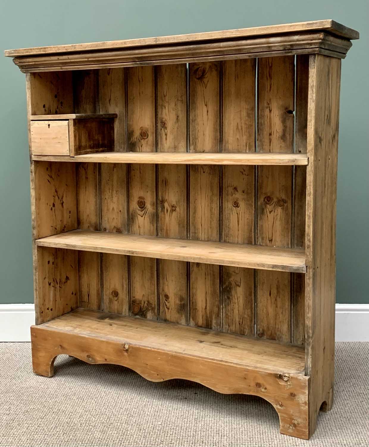 VINTAGE STRIPPED PINE BOOKCASE, with upper shelf single drawer box and shaped front apron, 125cms H,