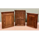 THREE ANTIQUE OAK / MAHOGANY WALL HANGING CORNER CUPBOARDS, 2 x single door and 1 x twin door, all