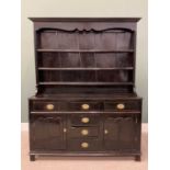 OAK AND PINE DRESSER, circa 1780 and later, having a wide boarded back to a three-shelf rack and a