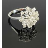 18CT WHITE GOLD TIERED STARBURST DIAMOND CLUSTER RING, having 25 individually claw set round