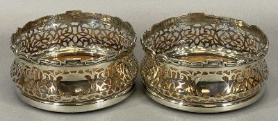 GOOD PAIR OF SILVER PLATED WINE BOTTLE COASTERS, late 19th Century, having shaped and detailed upper