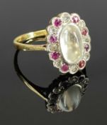 18CT YELLOW & WHITE GOLD MOONSTONE, DIAMOND & RUBY OVAL CLUSTER RING, the oval moonstone 10 x 6mm