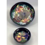 MOORCROFT CIRCULAR BOWL, 'Orchid and Iris' pattern on a blue ground, impressed marks and