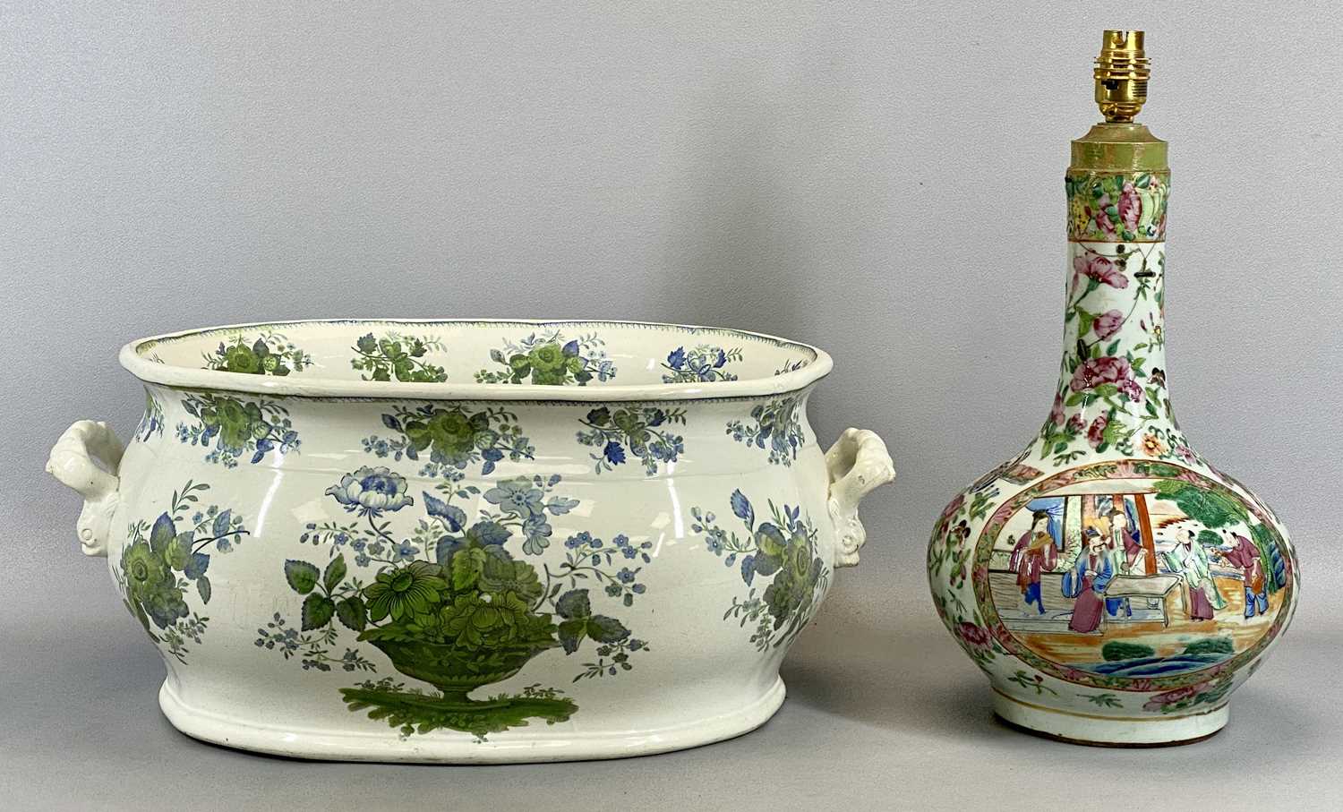 POTTERY TWO HANDLED FOOTBATH, late 19th Century, decorated in blues and greens with floral baskets