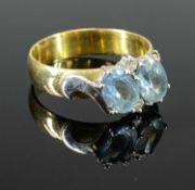 18CT GOLD AQUAMARINE & DIAMOND SET RING, having 2 x faceted oval aquamarines, 7 x 5mm approx.