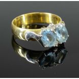 18CT GOLD AQUAMARINE & DIAMOND SET RING, having 2 x faceted oval aquamarines, 7 x 5mm approx.