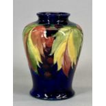 MOORCROFT VASE, of baluster form, leaf and berry pattern, signed and with impressed marks, 14cms H