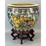 REPRODUCTION CHINESE EARTHENWARE FISH BOWL, panels decorated with figures on hardwood stand, 51cms