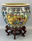 REPRODUCTION CHINESE EARTHENWARE FISH BOWL, panels decorated with figures on hardwood stand, 51cms