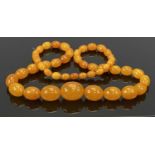 AMBER BEAD NECKLACE HOLDING 47 GRADUATING BEADS, 30mm across (the largest), 10mm across (the