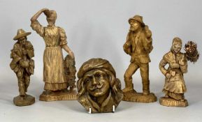 FOUR CONTINENTAL CARVED WOOD FIGURES 21cms H (the tallest), and a similar wall mask, 11 x 10cms